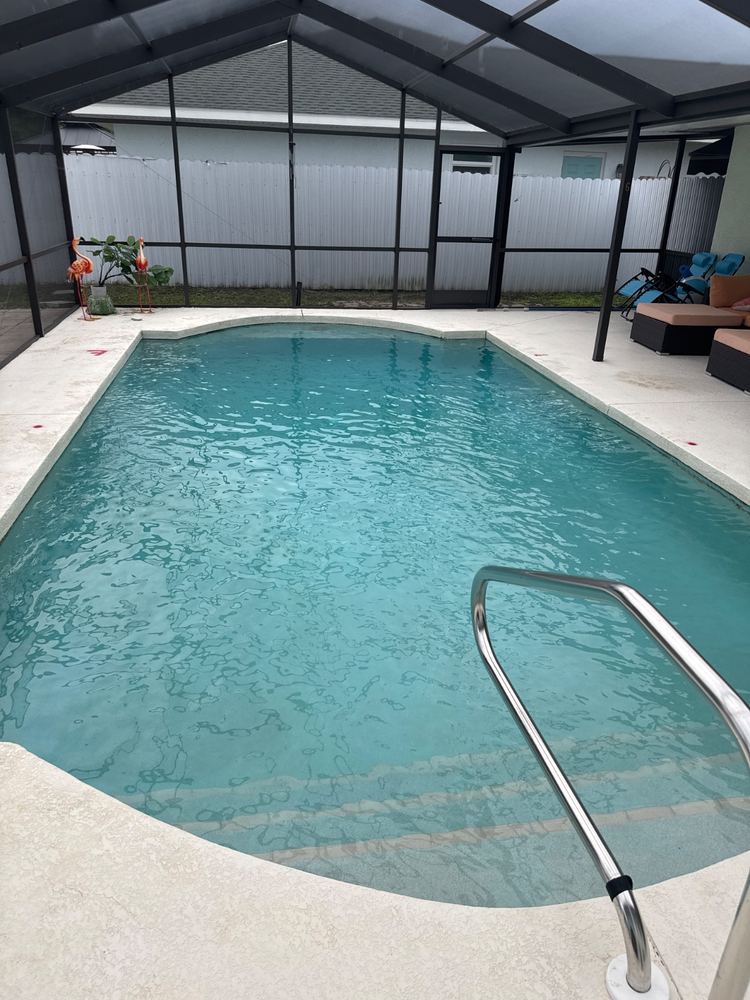 Pool with clean water and a handrail at the steps